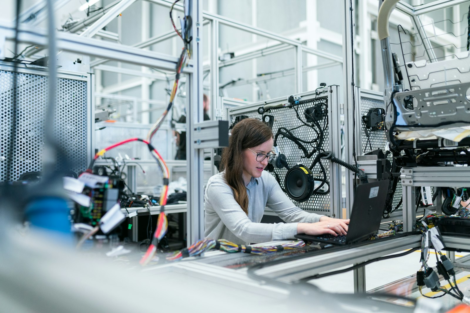 Engineers reviewing systems on a factory floor workstation
